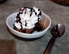 a white bowl filled with ice cream and chocolate