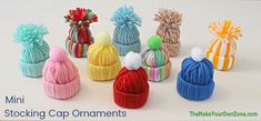 mini stocking cap ornaments in different colors and sizes are displayed on a white surface