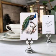 there are two cards on the table and one has a peacock sitting on top of it