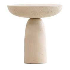 a white table with a round base on it