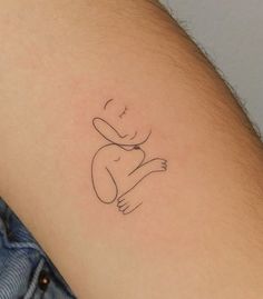 a person with a small tattoo on their arm