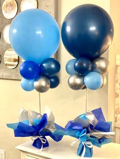 two blue and silver balloons are on display