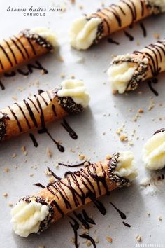 some food is laying out on a sheet of wax paper and drizzled with chocolate