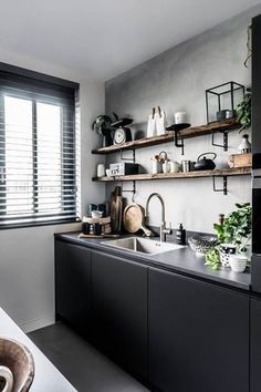 a black and white kitchen with open shelves