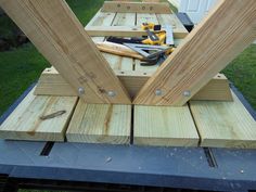 some tools are sitting on top of wooden boards