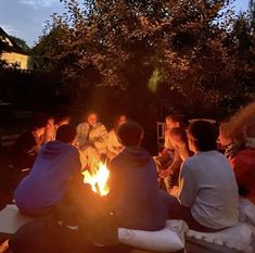 a group of people sitting around a fire pit