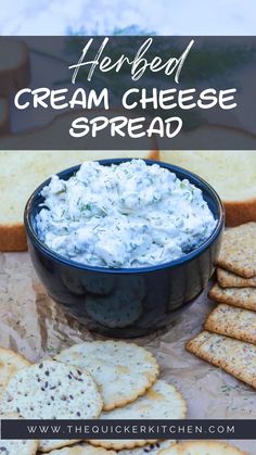 a blue bowl filled with cream cheese next to crackers