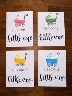 four little ones welcome cards on top of a wooden table