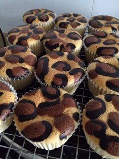 a bunch of cupcakes that are sitting on a cooling rack in the oven