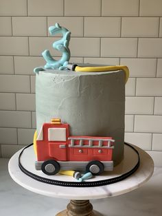 a birthday cake with a fire truck on top