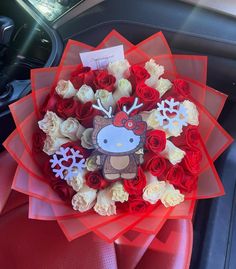 a bouquet of roses in the front seat of a car with hello kitty on it