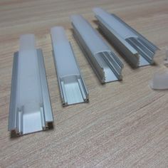 four different sizes and shapes of metal bars on a table