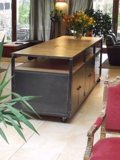 a living room filled with lots of furniture and flowers on top of a wooden table