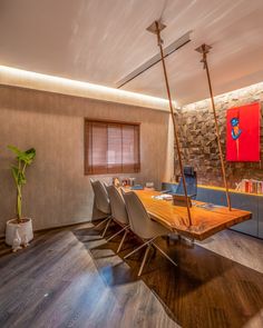 a wooden table surrounded by chairs in a room