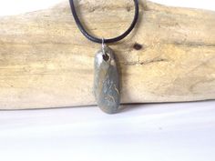 This pendant is made with a coastal stone, either ocean or river. The stone is not tumbled or shaped but is in its natural form, except for the drilled hole. Therefore, the stone/rock will have its natural "imperfections" just as nature made it. This adds character and uniqueness to the piece. They make a perfect gift for rockhounds, yoga\ Zen lovers, surfers or just anyone who loves the beauty of nature. This stone has some really interesting coloration and patterning, that is artistic in itsel Rock Pendant, Unique Beach, Natural Form, Boho Style Jewelry, Natural Rock, Beach Stones, Pull Apart, Rock Hounding, Natural Forms