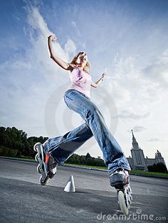 a young woman is riding her skateboard in the air with one foot on the ground