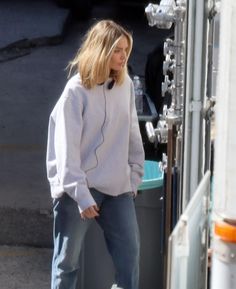 a woman standing next to a white truck