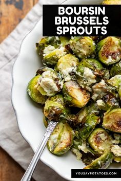 a white bowl filled with brussel sprouts on top of a wooden table