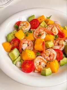 a white plate topped with shrimp and veggies