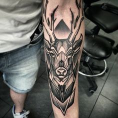 a man with a deer tattoo on his arm