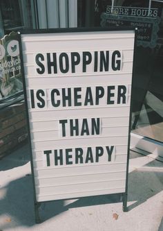 a sign that says shopping is cheaper than therapy