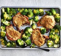 chicken and broccoli on a baking sheet with a spoon