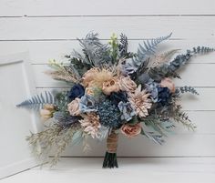 a bridal bouquet with blue and pink flowers