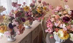 three vases filled with different types of flowers