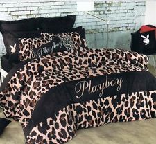 a bed with black and pink leopard print on the comforter, pillows and pillow cases