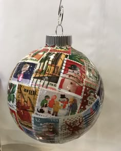 a christmas ornament hanging from a metal hook on a white background with images of people