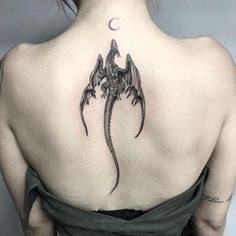 a woman with a dragon tattoo on her back