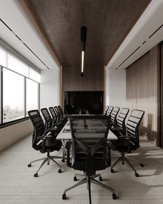 an empty conference room with black chairs and a large table in front of the window