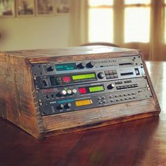 an old radio sitting on top of a wooden table