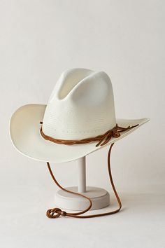 Sophisticated yet casual, our Grove western-style cowboy hat is crafted of woven shantung straw and features a generous downturned brim that will shade you from the sun's intensity. A twisted leather cord wraps around the Grove's tall crown, giving it a relaxed feel, while the interior sweatband assures fit and wicks moisture. This three-season hat embodies the rodeo spirit, even though it's always welcome at any social gathering. Dread Women, Female Dreads, Cowboy Hat Styles, Tall Crown, Business Travel Bag, Straw Cowboy Hat, Sheepskin Slippers, Western Hats, Social Gathering