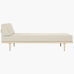 a white couch sitting on top of a wooden frame