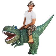 a man riding on the back of an inflatable dinosaur