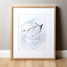 a watercolor painting of a tree branch on a white wall next to a wood floor