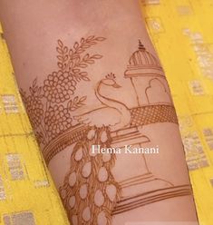 a woman's arm with henna tattoos on it