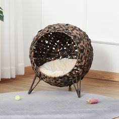 a wicker chair with a white cushion on the floor next to a toy snail