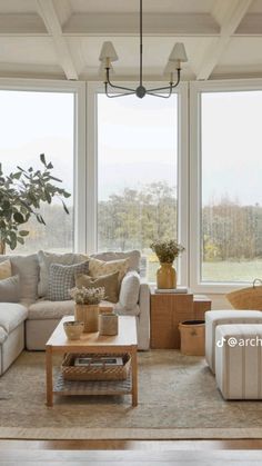 a living room filled with furniture and windows