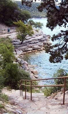 stairs lead down to the water from a rocky cliff