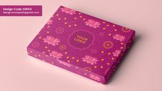 a pink gift box with floral designs on the front and side, sitting on a pink background