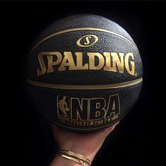 a person holding a basketball in their hand with the word spalding written on it