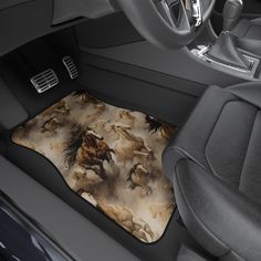 a car floor mat with horses on it