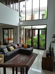 a living room filled with furniture and lots of windows