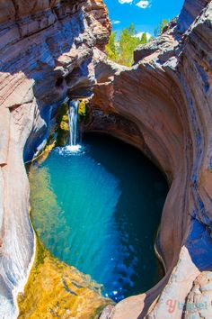 a small waterfall in the middle of a canyon