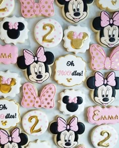 minnie mouse cookies are decorated with pink and white icing for the first birthday girl