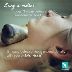 a woman laying in bed next to a dog with its head on her chest and the words being a mother doesn't mean being related to someone by blood