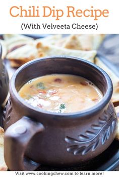 a bowl of soup sitting on top of a black plate