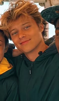 two young boys sitting next to each other in the back seat of a car together